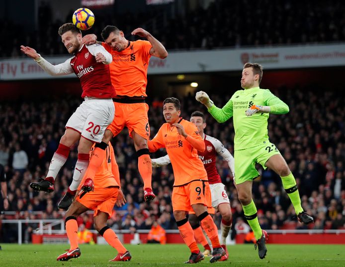 Soccer Football - Premier League - Arsenal vs Liverpool - Emirates Stadium, London, Britain - December 22, 2017   Arsenal's Shkodran Mustafi in action with Liverpool's Dejan Lovren and Simon Mignolet             REUTERS/Eddie Keogh    EDITORIAL USE ONLY. No use with unauthorized audio, video, data, fixture lists, club/league logos or "live" services. Online in-match use limited to 75 images, no video emulation. No use in betting, games or single club/league/player publications.  Please contact your account representative for further details.