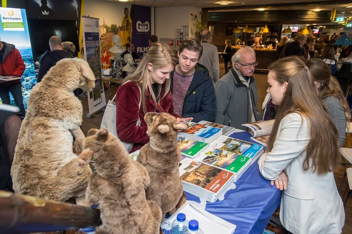 Bezoekers van de vakantiebeurs nemen een kijkje bij de folders.