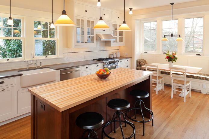 A bar table is a cheaper alternative to a kitchen island.