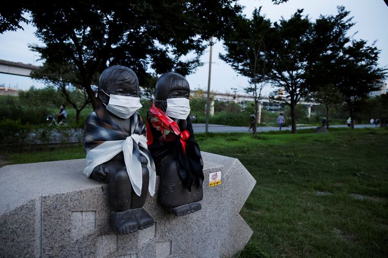 Een standbeeld van een broer en zus in de Zuid-Koreaanse hoofdstad Seoul heeft mondkapjes op gekregen. Beeld REUTERS