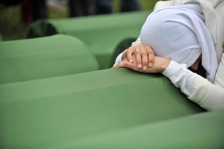 Een overlevende van de Val van Srebrenica huilt bij de kist van een familielid op het kerkhof in Potocari, in de buurt van Srebrenica. Beeld AFP