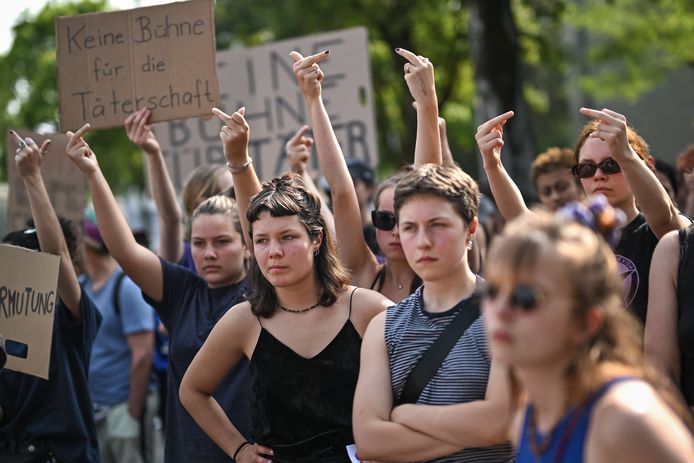 Zwaaiend met spandoeken met berichten als “Ik geloof haar” en “Stop de verkrachtingscultuur”, staken de betogers hun middelvingers op in de richting van de in het zwart geklede fans van Rammstein.