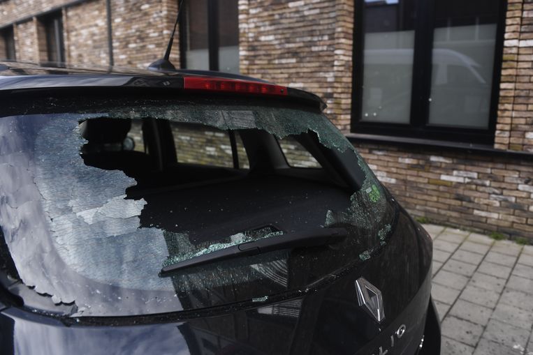 Een beschadigde wagen in de Biekorfstraat, nadat er een granaat ontplofte. Beeld BELGA