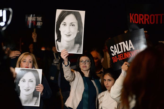 Protesters hold up placards and pictures of the late journalist Daphne Caruana Galizia as they gather outside the prime minister's office in Valletta, Malta on November 20, 2019, the day Maltese businessman Yorgen Fenech, who is believed to be the mastermind behind her assassination, was detained on his yacht after he tried to leave Malta. - Malta on November 20 arrested a tycoon in connection with the murder of journalist Daphne Caruana Galizia, the day after an alleged middleman was offered a pardon to identify the mastermind behind the killing. Maltese national Yorgen Fenech was detained on his yacht at dawn as he tried to leave Malta, in the latest development in the long-running case that has raised questions about the rule of law in Malta. (Photo by Matthew Mirabelli / AFP)
