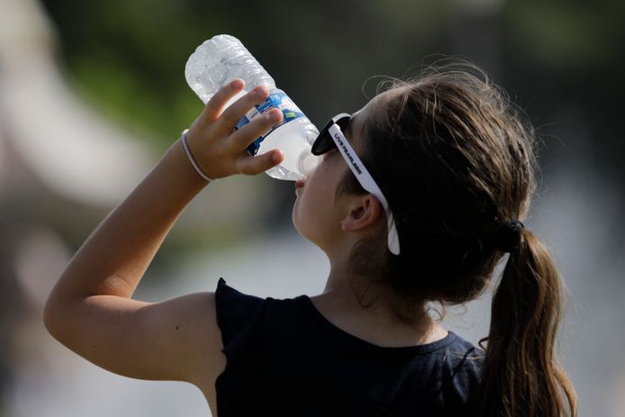 Een meisje drinkt water tijdens de hittegolf van 2019.
