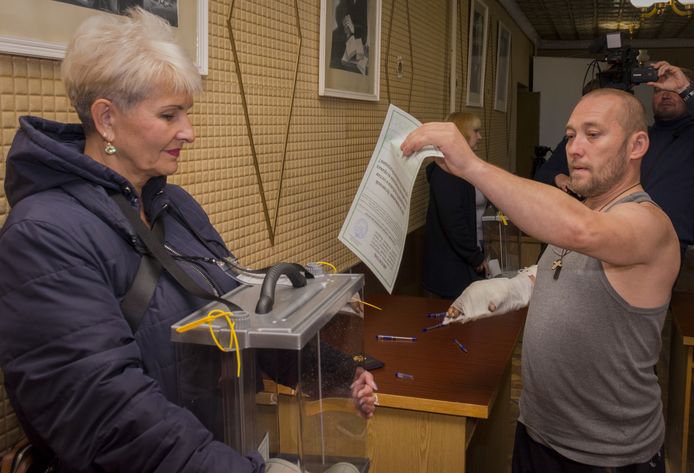 Een inwoner van Loehansk stopt zijn stembiljet in de doorzichtige stembus. Vanaf vandaag tot dinsdag kan er in vier regio's in Oekraïne via een referendum worden gestemd of inwoners zich willen aansluiten bij Rusland.