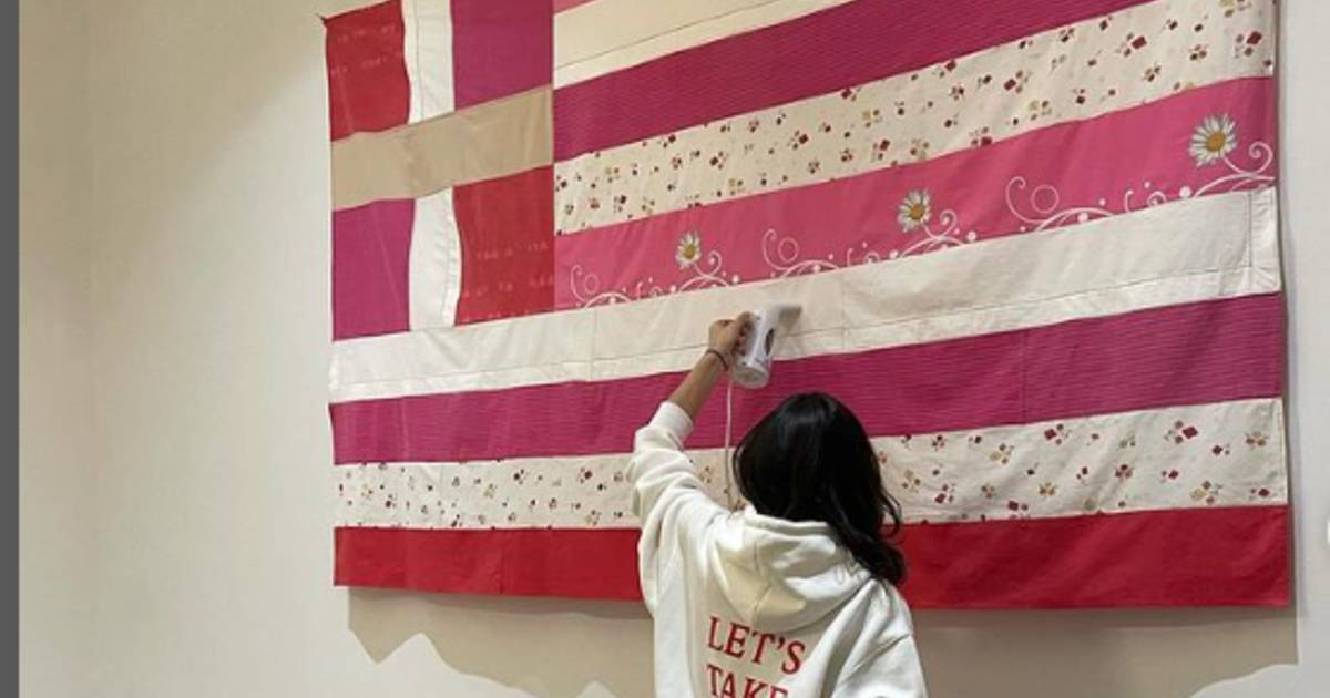 Greece in uproar over artistic version of national flag with pink stripes symbolizing victims of domestic violence