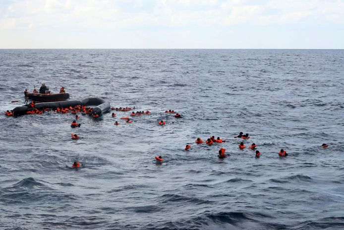 Bootvluchtelingen worden op de Middellandse Zee gered door de  humanitaire organisatie Open Arms nadat hun veel te kleine en instabiele rubberboot kapot gegaan is in het water.