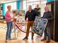 Christel Bruggink (links) van Stichting Verjaardag in de Maak samen met koper Mark Maathuis (midden) en kunstenaar Paul Tieke (kunstschilder). De Almelose Sterren op het Doek werd georganiseerd bij Het Huis van Katoen onder leiding van Edwin Lette (rechts achter).