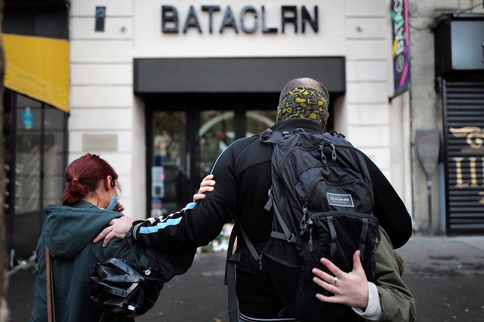 FILE - In this Nov.13, 2020 file photo, relatives pay their respects outside the Bataclan concert hall marking the 5th anniversary of the Nov. 13, 2015 attacks, in Paris. France is putting on trial 20 men accused in the Nov. 13, 2015, Islamic State terror attacks on Paris that left 130 people dead and hundreds injured. Nine gunmen and suicide bombers struck within minutes of each other at the national soccer stadium, the Bataclan concert hall and restaurants and cafes . (AP Photo/Francois Mori,FILE)