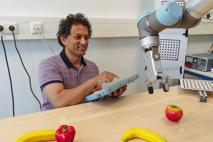 Aneesh Chauhan van Wageningen Universiteit aan de slag met de robot die groente en fruit kan selecteren.