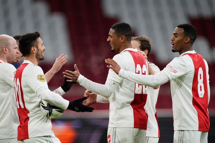 Ajax players celebrate a goal against Willem II.