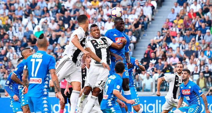 Juventus' Alex Sandro and Napoli's Kalidou Koulibaly, top right, jump for the ball during the Serie A soccer match between Napoli and Juventus at the Allianz Stadium in Turin, Italy, Saturday, Sept. 29, 2018. (Alessandro Di Marco/ANSA via AP)
