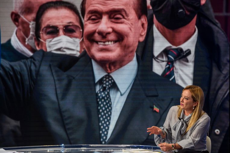 Giorgia Meloni, leider van de Broeders van Italië, met op de achtergrond een foto van ex-premier Silvio Berlusconi. Beeld Getty Images