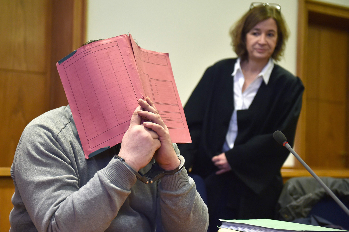 Niels H. verbergt z'n gezicht tijdens het proces in 2015. Naast hem zijn advocate Ulrike Baumann.