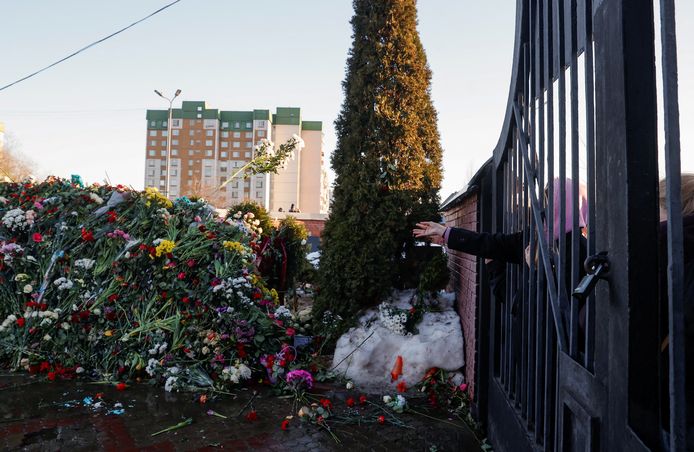 Someone throws flowers inside when the cemetery is closed.