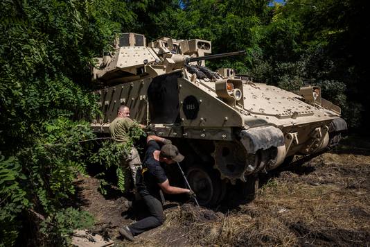 Ukrainian mechanic and soldiers repair an American armored vehicle near Zaporizhna.