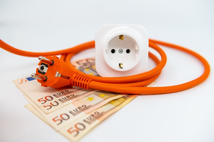 Euro banknotes under a power cable. Expensive concepts of energy and cost of electricity. Front view. Electric power cable with plug and socket unplugged