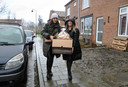Amy Johnson (l) en Laura Lafranca delen donderdagmiddag pakketten voedsel en andere boodschappen uit aan vluchtelinggezinnen op Schouwen-Duiveland.