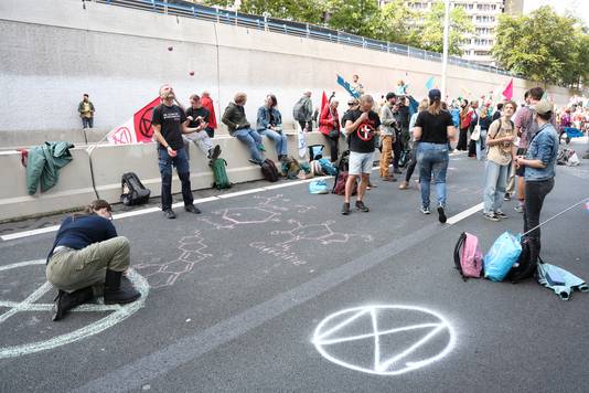 Demonstranten tekenen logo's op de weg.