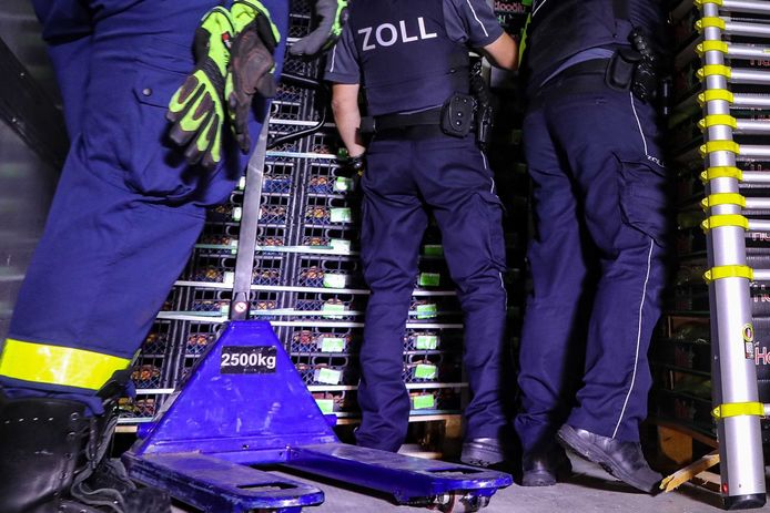 Politie en douane controleren koelwagen nadat 31 migranten werden aangetroffen.
