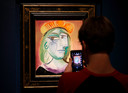 Een bezoeker neemt een foto van Pablo Picasso's schilderij van zijn minnares en muze Marie-Thérèse uit 1938 tijdens een bezichtiging in het Bellagio hotel in Las Vegas voorafgaand aan de veiling. Het werk werd zaterdag geveild voor bijna 35 miljoen euro.