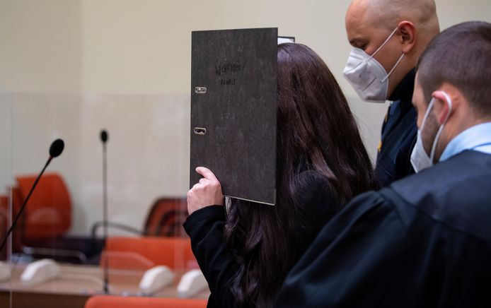 Jennifer Wenisch houdt een map voor haar hoofd in de rechtszaal in München.
