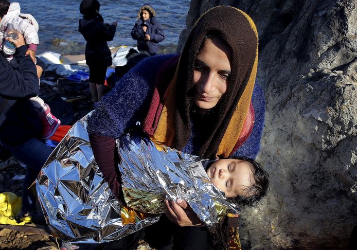 Een Afghaanse migrant draagt haar baby het eiland Lesbos op. Archieffoto uit 2015.