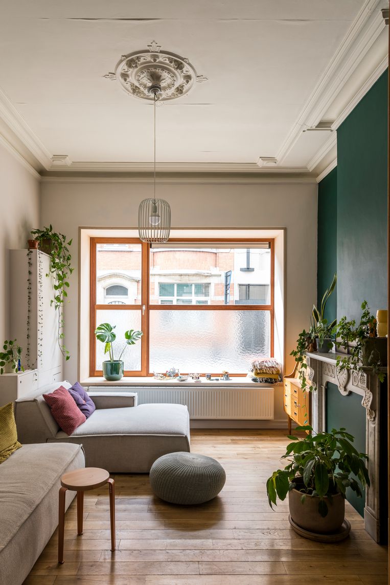 In the living room, the authentic elements have been restored: the wooden floor, the original moldings and the marble fireplace add to the charm of the house.  The raised window has a wide window sill that also serves as a reading area.  Image Luc Roymans