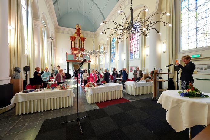 Burgemeester Miranda de Vries heft in de Van Goghkerk het glas met de zes Etten-Leurenaren die maandag een lintje ontvingen.