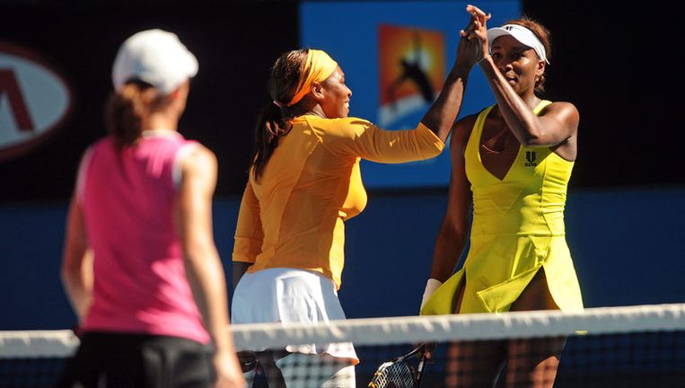Serena Williams (midden) en Venus Williams (rechts) na hun zege in het dubbelspel. Foto EPA Beeld 