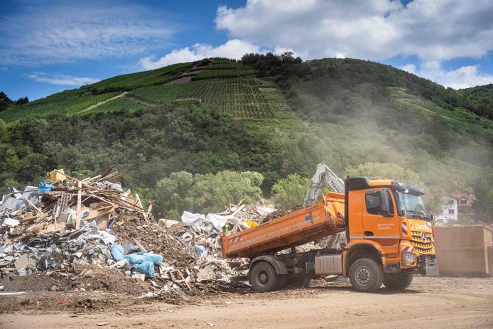 Une photo prise le 30 juillet 2021 montre un camion déchargeant des déchets à la décharge temporaire de déchets dans le village viticole de Rech, près de Dernau, sur la rivière Ahr, dans l'ouest de l'Allemagne, quelques semaines après que de fortes pluies et des inondations ont causé d'importants dégâts dans la région de l'Ahr.