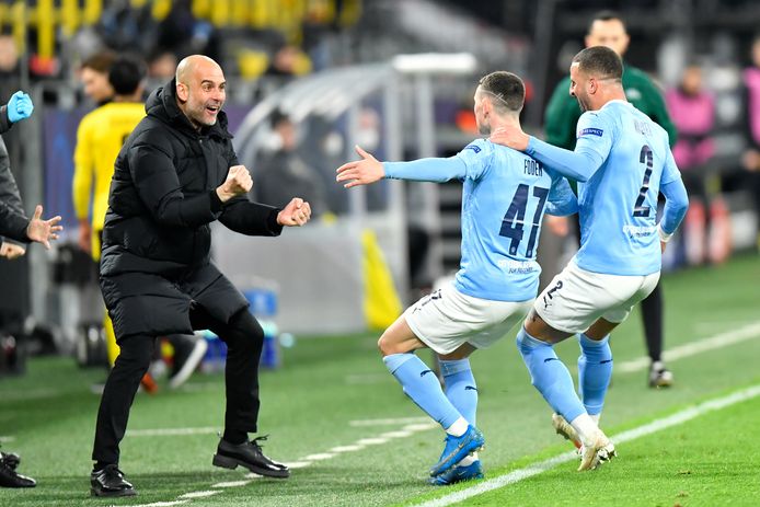 City-coach Pep Guardiola (l) viert de 2-1 met zijn spelers.