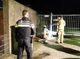 De brandweer van Gennep helpt de politie met het losmaken van de ketting aan de poort van het politiebureau.