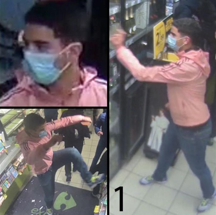 Persoon 1 droeg een blauwe jeans en een roze sweater met kap van het merk “Adidas”.