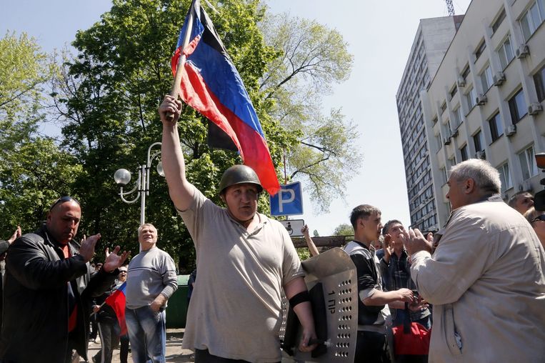 Een man houdt de vlag omhoog van Volkskrepubliek Donetsk die deze week door pro-Russische separatisten is uitgeroepen. Beeld epa
