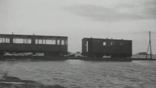 Een tram op Schouwen-Duiveland steekt in februari 1953 nog boven de waterlijn uit.  Verder is er in de directe omgeving niets te zien dan water.