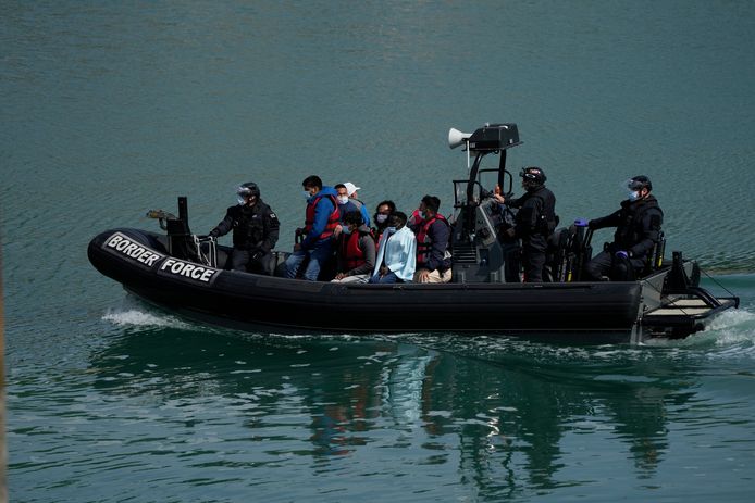 Britse grenswacht met mensen die van een bootje zijn gehaald tijdens een poging om het Kanaal over te steken. Beeld ter illustratie.