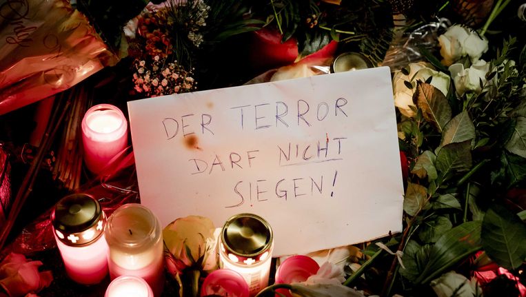 Kaarsen en bloemen in de buurt van de plek waar een vrachtwagen afgelopen maandagavond inreed op een kerstmarkt in Berlijn. Daarbij vielen 12 doden en 49 gewonden, van wie een aantal nog in ziekenhuizen ligt. Beeld ANP