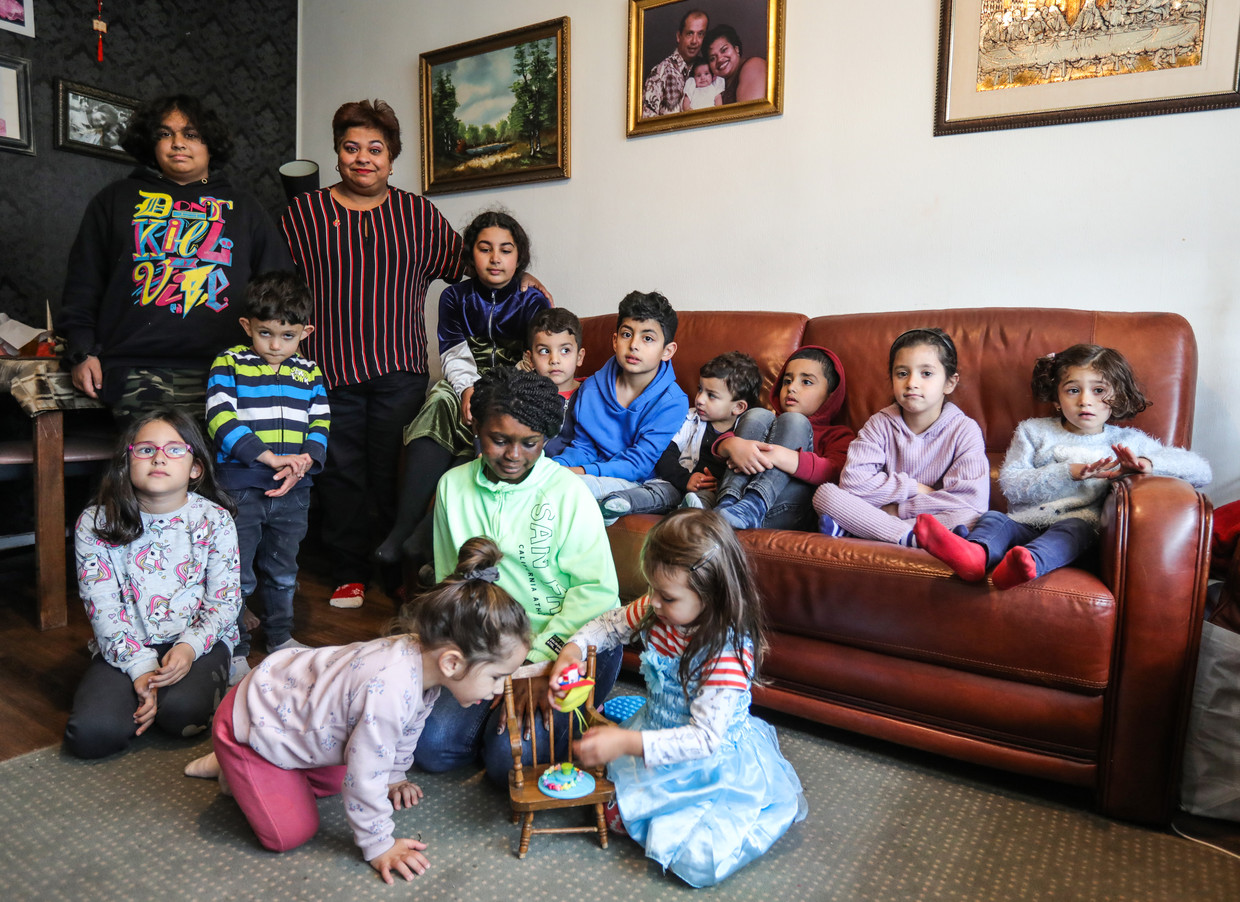 Risma Soekhi met allemaal buurtkinderen, in haar huiskamer. Beeld Eva Plevier