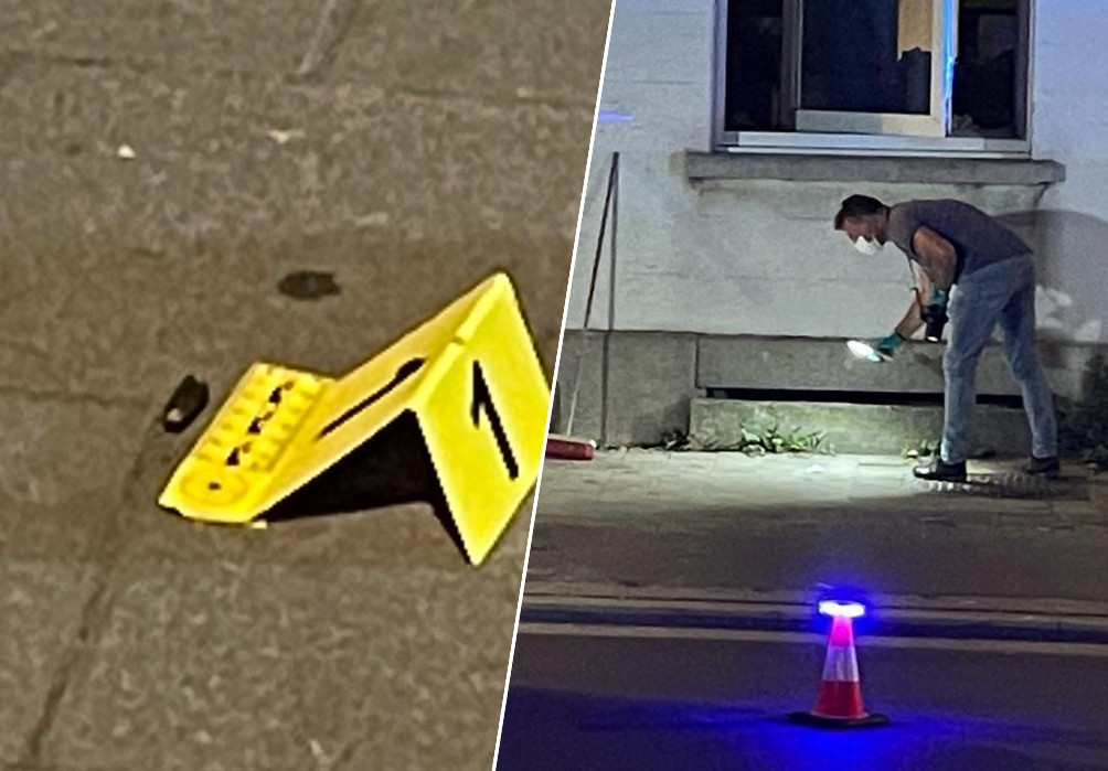 De huls van een kogel ligt op het voetpad waar een laborant van de politie verder naar sporen zoekt.