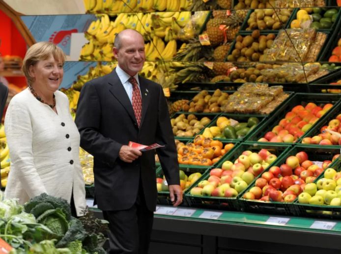 Karl-Ervan Hope with former German Chancellor Angela Merkel in one of his supermarkets.