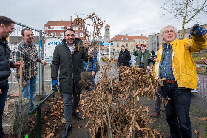 Wethouder Yasin Torunoglu (links) en Harry Janssen van de buurtvereniging halen beukenhaagjes weg bij het Vogelzangterrein en planten ze bij het Lodewijk Napoleonplein in Eindhoven.