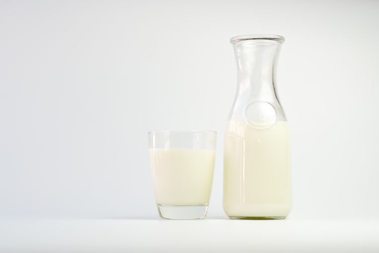 Soy milk in a glass and a bottle on a white background Beeld Getty Images