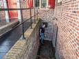 Jan Wessels, onderaan de trap naar de archeologiekelder van het stadhuis, waar een onbekende vaker zijn behoefte doet.