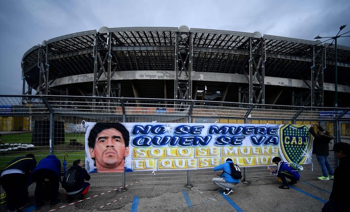 Boca Junior fans hang a banner at the Napoli stadium.