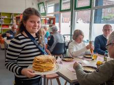 Ouderen en kinderen eten samen pannenkoeken