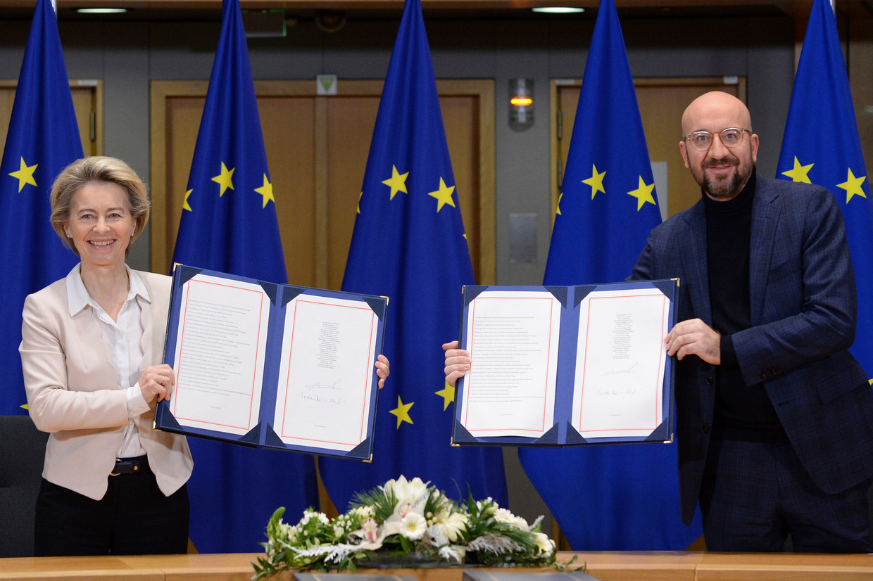 Commissievoorzitter Ursula von der Leyen en EU-president Charles Michel tonen de ondertekende handelsovereenkomst met het Verenigd Koninkrijk in Brussel.  Beeld AP
