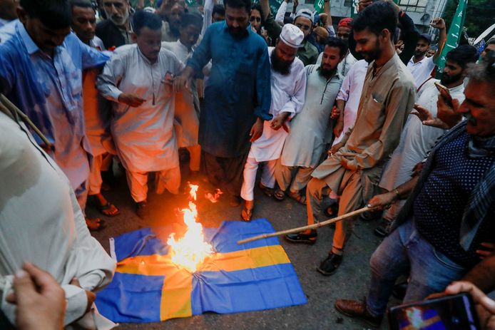 Supporters of Tehreek-e-Labaik Pakistan, a religious and political party, burn a Swedish flag during a protest against the desecration of the Quran outside a mosque in Stockholm, in Karachi, Pakistan, July 7, 2023.