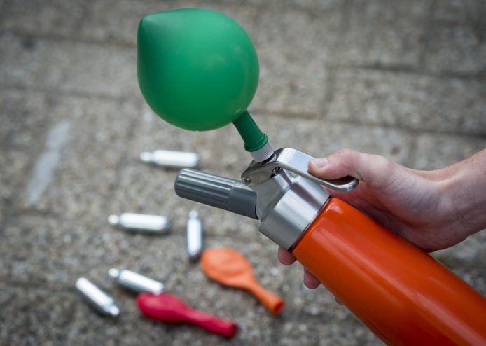 Foto ter illustratie: patronen met lachgas, ballonnen en een slagroomspuit.